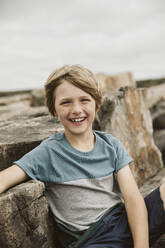Portrait of happy boy at seaside - JOHF08890