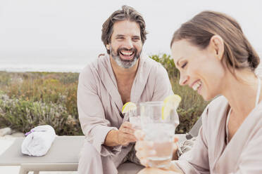 Happy relaxed couple with drinks on terrace - SDAHF00538