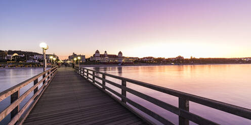 Germany, Mecklenburg-West Pomerania, Rugen Island, Binz, Ostseebad, Pier and sea at sunset - WDF05764