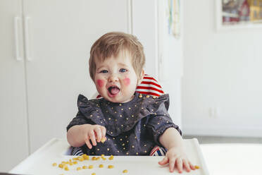 Girl sitting in high chair - JOHF08997