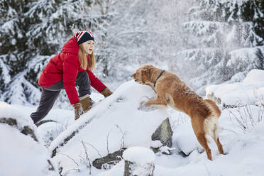 Girl playing with dog - JOHF09029