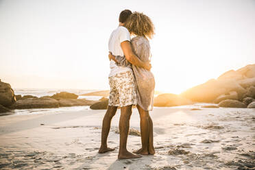 Couple hugging on the beach enjoying the sunset - SDAHF00621