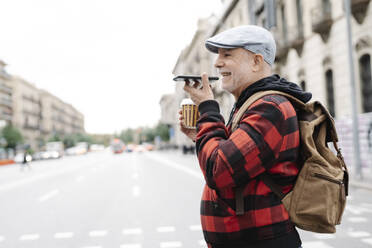 Senior man on the phone crossing the street, Barcelona, Spain - JCZF00010