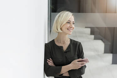 Portrait of smiling businesswoman with mobile phone - BMOF00169