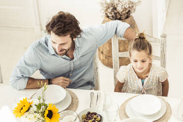 Father and daughter sitting at dining table - SDAHF00637
