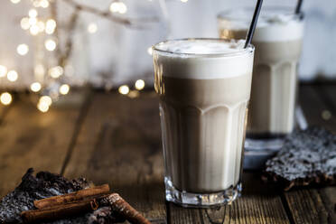 Glass of iced chai with frothy milk and cinnamon - SBDF04214