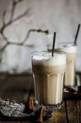 Glass of iced chai with frothy milk and cinnamon - SBDF04217