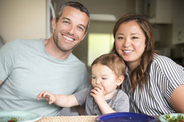 Portrait happy young family eating - CAIF23793