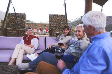 Ältere Freunde trinken Wein auf der Hotelterrasse - CAIF23986