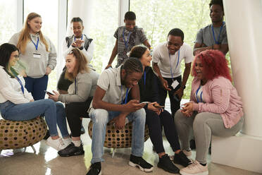 High school students hanging out and using smart phones - CAIF24096