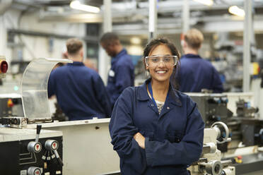 Portrait confident young female college student in shop class - CAIF24157