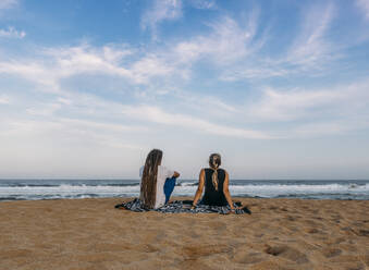 Couple relaxing on tranquil ocean beach Kiama Australia - CAIF24195