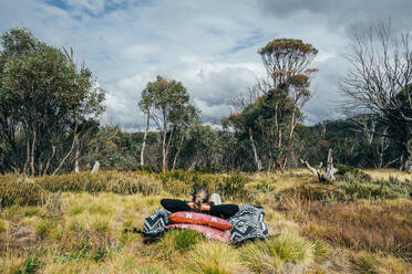 Unbeschwerte Frau entspannt sich im Wald Alpine National Park Australien - CAIF24215