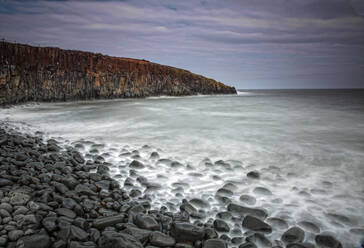 Rocks on remote ocean beach Cullernose Point Craster Northumberland UK - CAIF24222