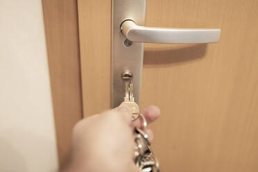 Germany, Hand of man locking home door - CHPF00654