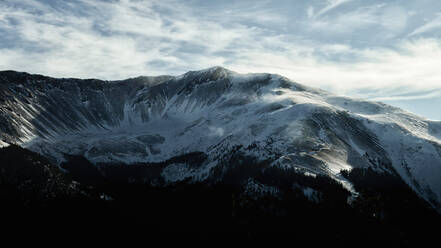 Wide angle of snow blowing across mountains near WinterPark - CAVF74957