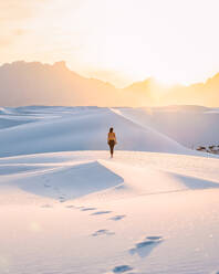 Woman on white sand dunes, White Sands National Monument, New Mexico, US - ISF23792