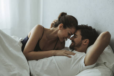 Happy affectionate couple in bed stock photo