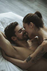 Happy affectionate couple in bed - SHKF00812