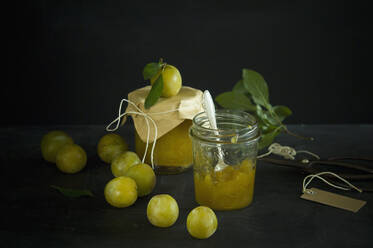 Studio shot of greengages and jars of homemade plum jam - ASF06577