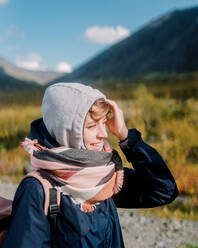 Close-up portrait of an attractive woman standing among the mountains - CAVF75078