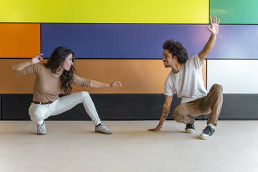 Dancers practicing in front of colorful wall - DLTSF00550