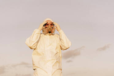 Portrait of man wearing protective suit and mask - ERRF02668