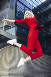 Blond businesswoman wearing red suit - JSMF01467