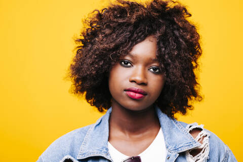 Portrait of beautiful serious young woman in studio stock photo