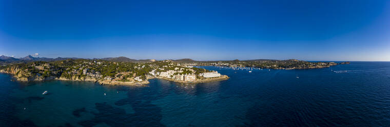 Spain, Balearic Islands, Costa de la Calma, Aerial panorama of clear blue sky over coastal town in summer - AMF07878