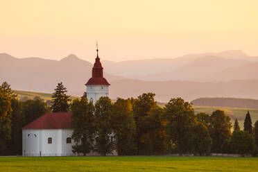 Rural landscape with a church in Turiec region, central Slovakia. - CAVF75418