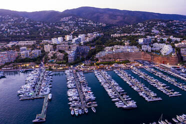 Spain, Balearic Islands, Mallorca, Portals Nous, Puerto Portals, Aerial view of luxury marina at sunset - AMF07879