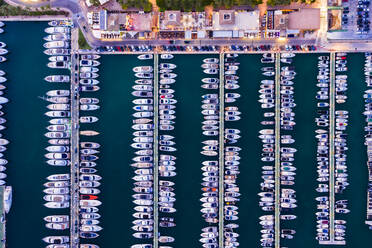 Spain, Balearic Islands, Mallorca, Portals Nous, Puerto Portals, Aerial view of luxury marina at sunset - AMF07881