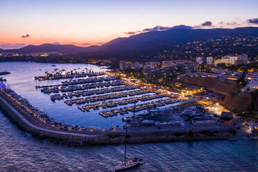 Spain, Balearic Islands, Mallorca, Portals Nous, Puerto Portals, Aerial view of luxury marina at sunset - AMF07886