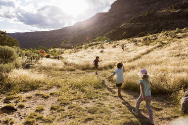 Children hiking at sunset,Pilar, NM. - MINF13830