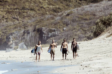 Male surfers standing on beach - CAVF75481