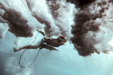 Surfer on surfboard, underwater shot - CAVF75483