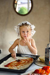 Little girl cooking pizza in the kitchen - CAVF75500