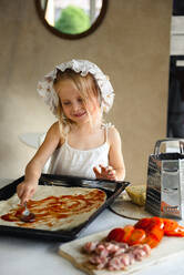Little girl cooking pizza in the kitchen - CAVF75502