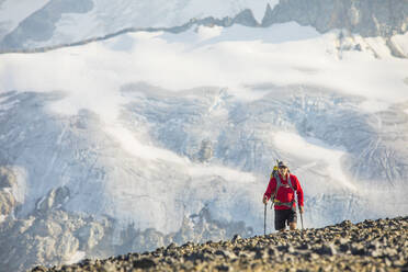 View of hiker against large glacier across valley. - CAVF75530