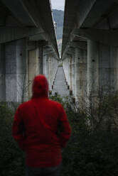 Man at a highway bridge in abandoned environment - RAEF02357