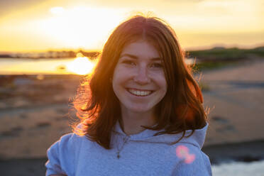 Portrait of smiling redheaded teenage girl at the coast, Halland, Sweden - LBF02899