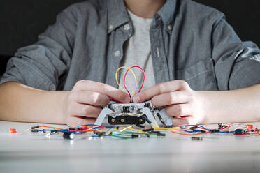 Boy assembling robot at home - EYAF00946