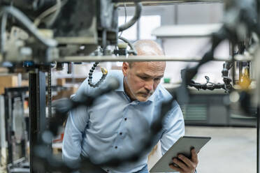 Businessman using tablet in a factory - DIGF09296