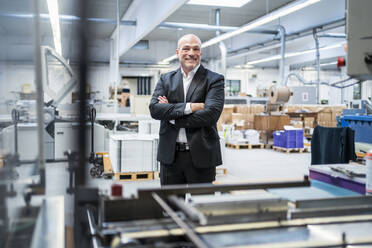 Portrait of a confident businessman in a factory - DIGF09318