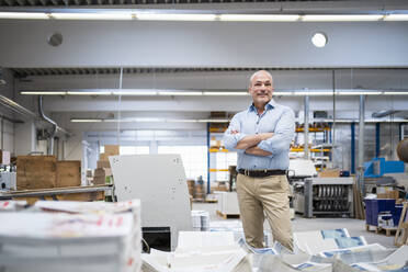 Portrait of a confident businessman in a factory - DIGF09347