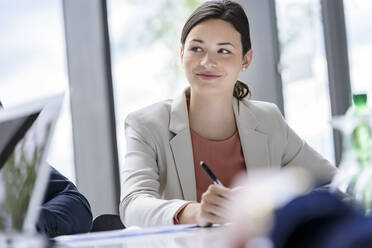 Attentive businesswoman sitting meeting, listening focussed - BMOF00203