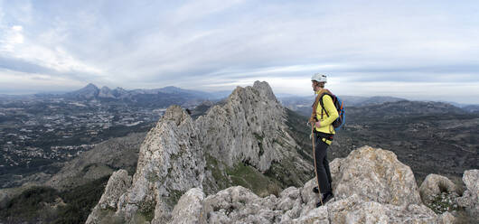 Woman mountaineering at Bernia Ridge looking at view, Costa Blanca, Alicante, Spain - ALRF01729