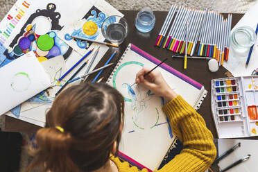 Woman painting with watercolours, top view - WPEF02672