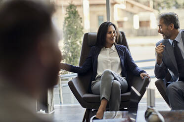 Business people having a meeting in hotel lobby - ZEDF02983